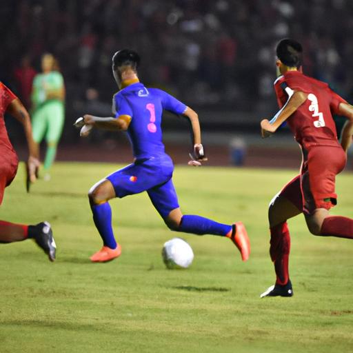 Cầu thủ Thái Lan đi bóng qua hàng phòng ngự đối thủ trong trận đấu tại Asian Cup
